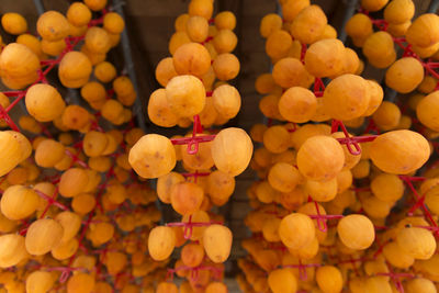 Full frame shot of orange fruits hanging at market