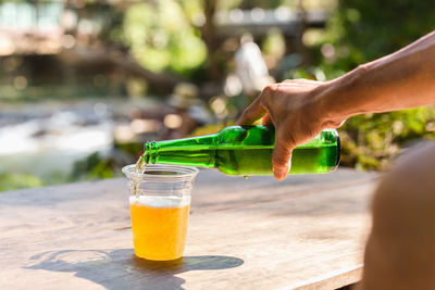 Cropped hand of woman holding drink