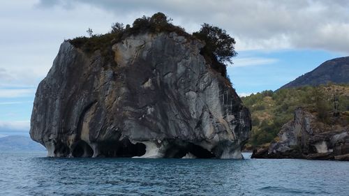 Scenic view of rocky mountains against cloudy sky