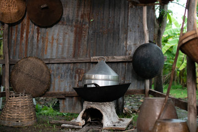 Old fashioned hanging from wooden logs against wall