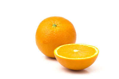 Close-up of orange fruit against white background