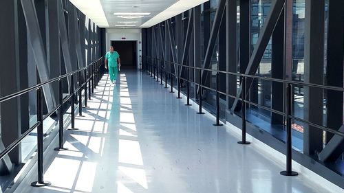 Full length of man walking in hospital corridor