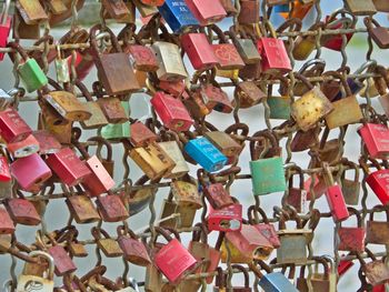 Close-up of padlocks hanging on railing