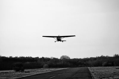 Low angle view of airplane against clear sky