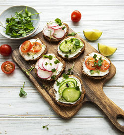 Sandwiches with healthy vegetables and micro greens on a wooden table