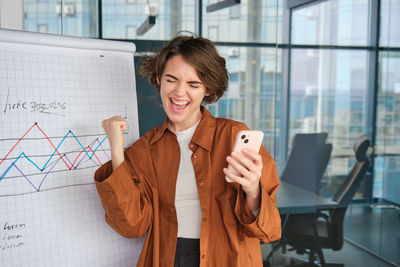 Portrait of young woman using mobile phone