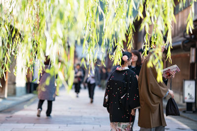 Rear view of women walking outdoors