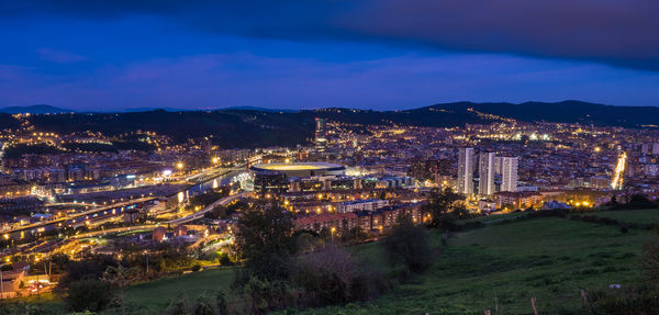 High angle view of illuminated buildings against sky at night
