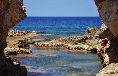 Scenic view of sea against clear blue sky