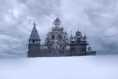 Traditional building against sky during winter