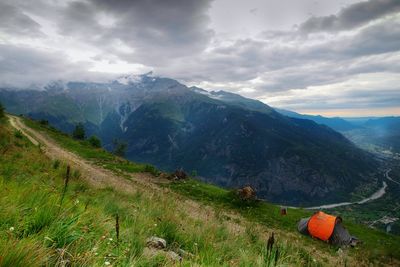 Scenic view of mountains against cloudy sky