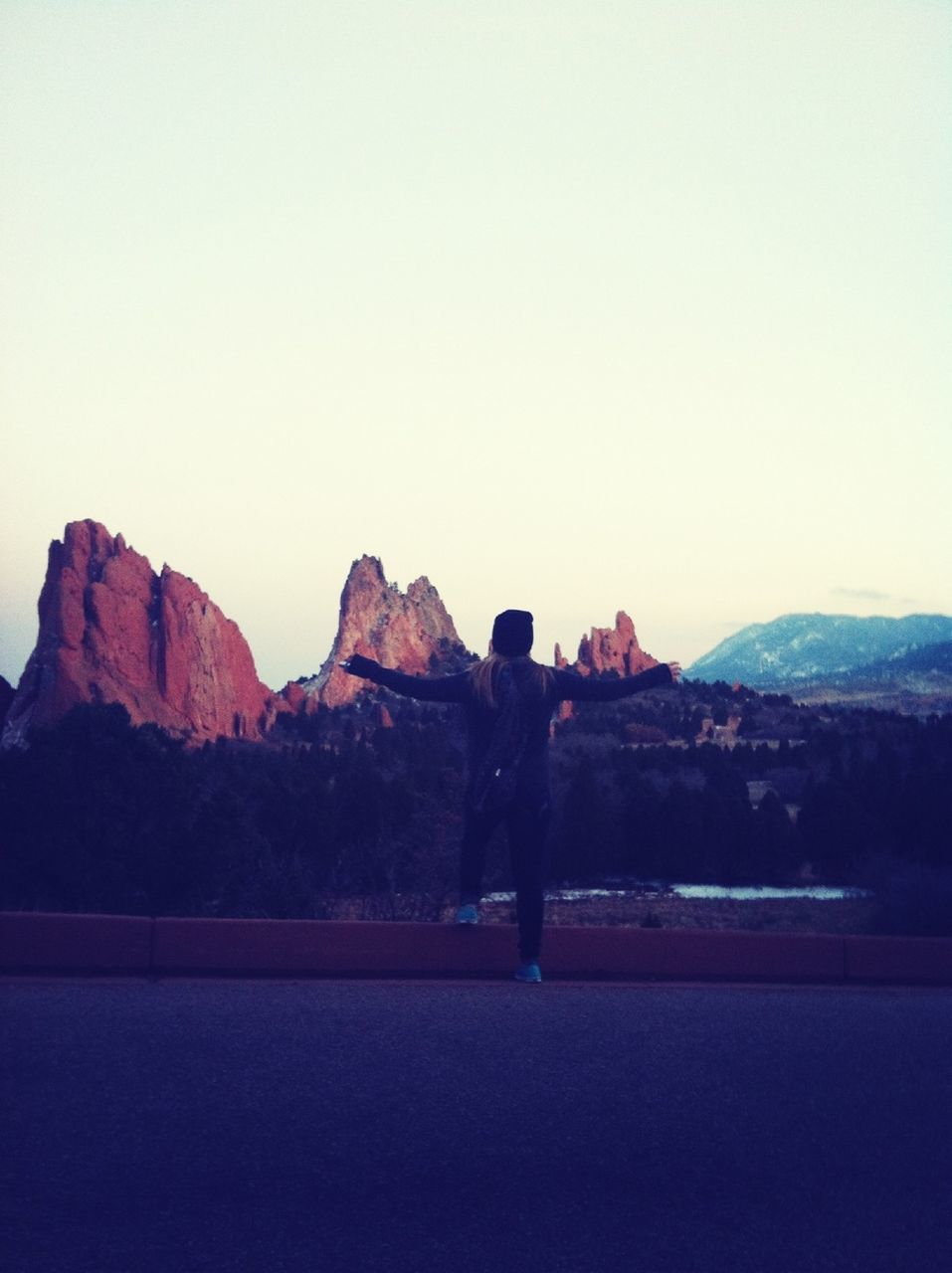 clear sky, mountain, copy space, men, silhouette, leisure activity, tranquil scene, full length, lifestyles, tranquility, rear view, mountain range, rock - object, landscape, standing, scenics, rock formation, nature