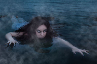 Portrait of young woman in sea