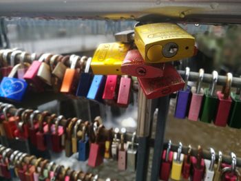 Close-up of padlocks hanging on railing