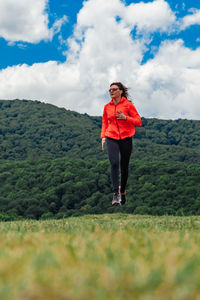 Rear view of woman standing on field