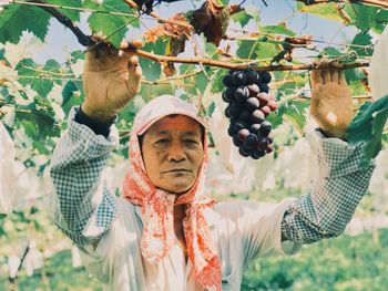 Portrait of man holding fruits