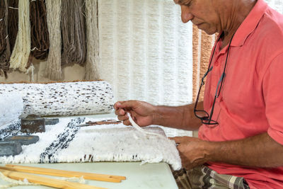 Side view of a man holding paper