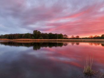 Scenic view of lake against sky at sunset