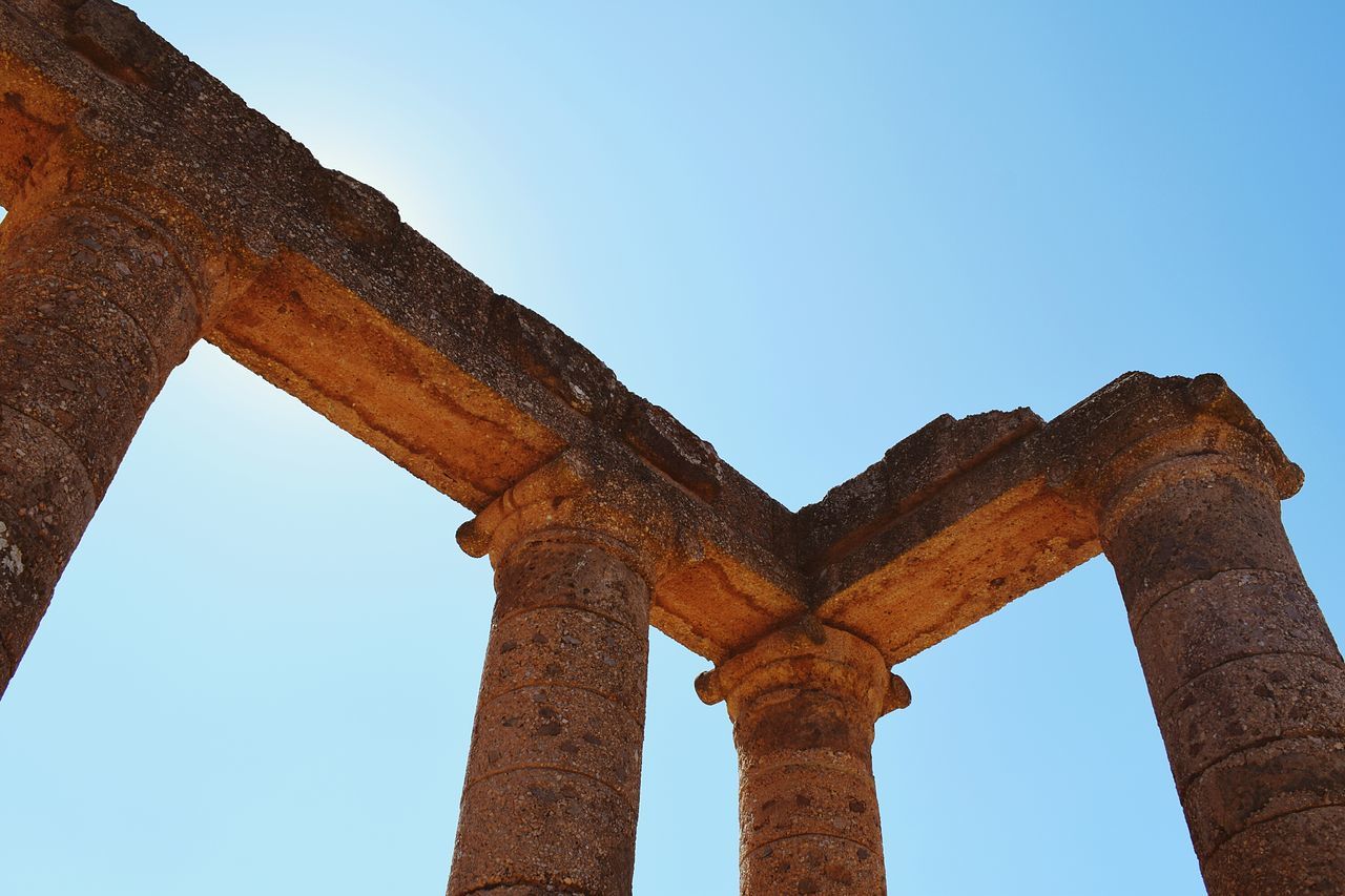 old ruin, history, the past, ancient, low angle view, archaeology, arch, ancient civilization, damaged, weathered, architecture, architectural column, clear sky, built structure, travel destinations, bad condition, run-down, day, abandoned, blue, no people, outdoors, sky, nature