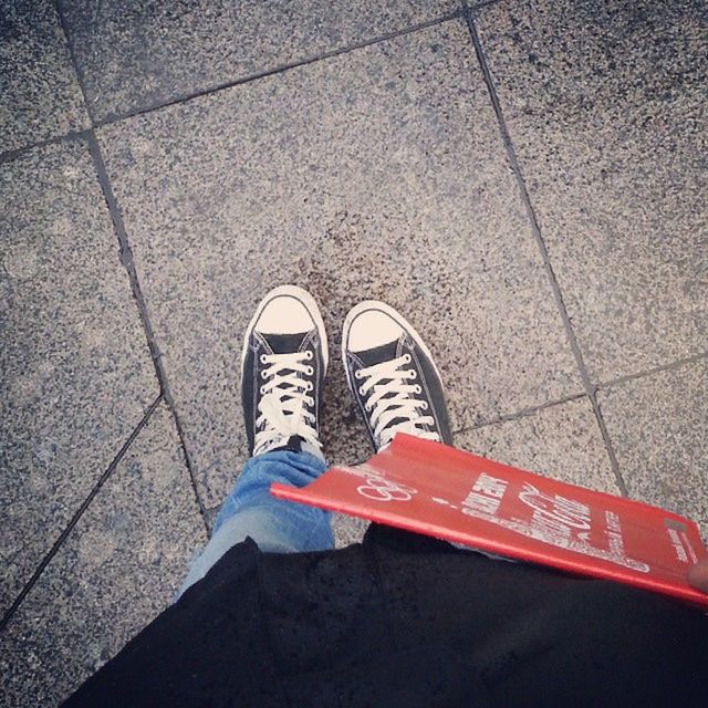 shoe, low section, high angle view, person, street, personal perspective, footwear, standing, paving stone, road, human foot, sidewalk, cobblestone, red, footpath, outdoors, lifestyles, directly above