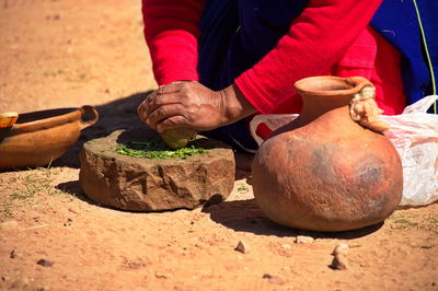 Traditional customs on the island of taquile. a woman makes soap from natural materials