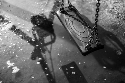 High angle view of swing over puddle at playground