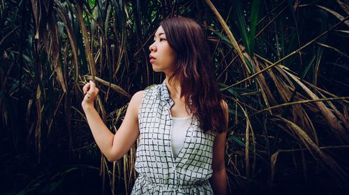 Beautiful young woman looking away outdoors