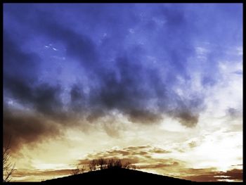 Low angle view of cloudy sky at sunset