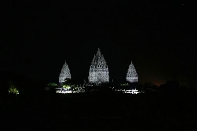 Illuminated temple building against sky at night