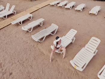 High angle view of child lying on sand