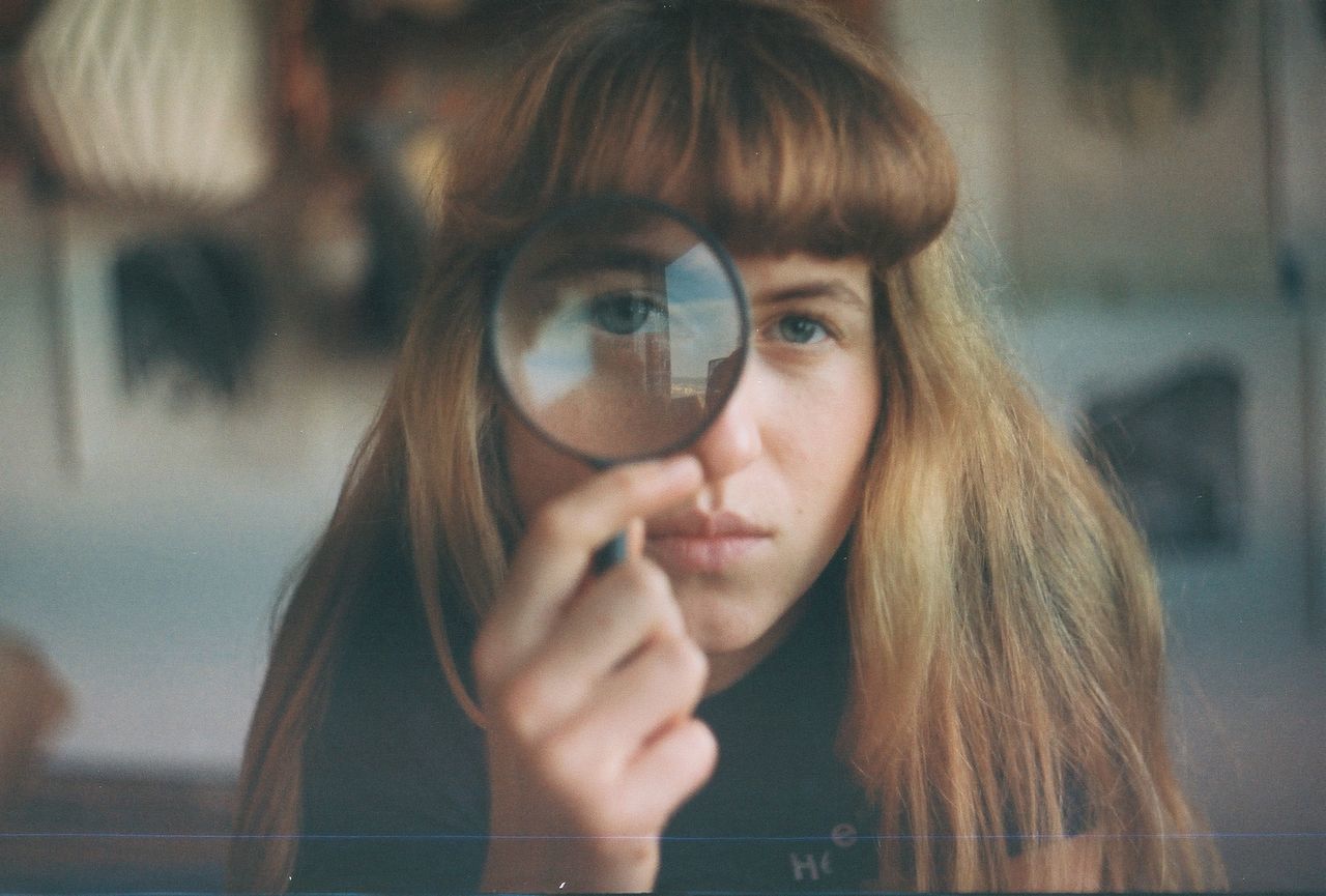 portrait, one person, real people, headshot, holding, front view, looking at camera, glass - material, young adult, reflection, indoors, focus on foreground, young women, transparent, adult, women, selective focus, leisure activity, hairstyle, bangs, beautiful woman