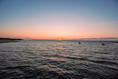 Scenic view of sea against orange sky