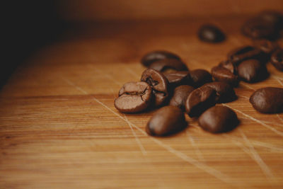 Close-up of roasted coffee beans on wooden table
