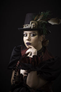 Woman in costume against black background