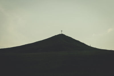 Silhouette of mountain against sky at dusk