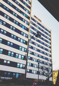 Low angle view of modern skyscraper against sky