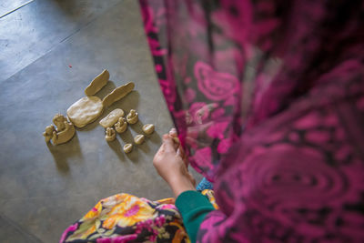 High angle view of woman holding paper