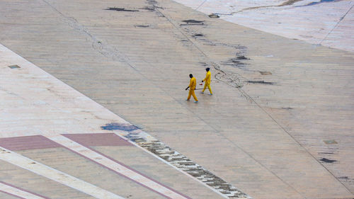 High angle view of people walking on road