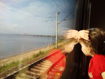 Girl looking through window