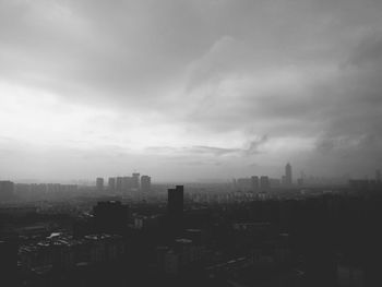 Cityscape against cloudy sky