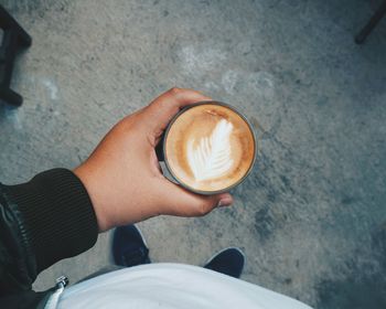 Low section of man holding coffee