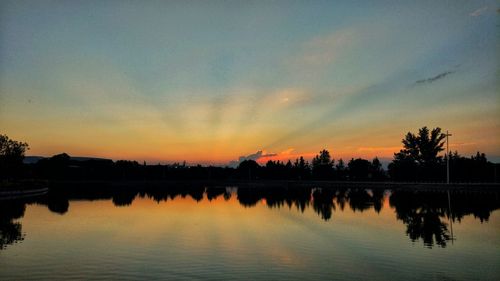 Scenic view of lake against sky during sunset