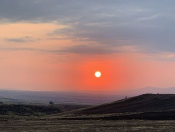 Scenic view of field against sky during sunset