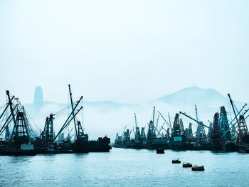 Boats in sea against clear sky