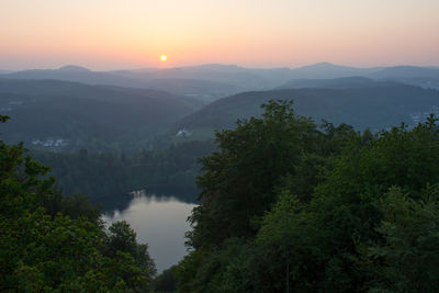 Scenic view of lake against sky during sunset