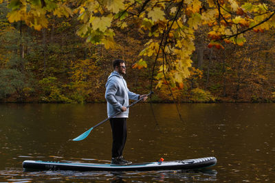 Rear view of man kayaking in lake