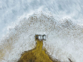 Low angle view of snow on sea against sky