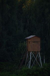 Built structure by trees in forest