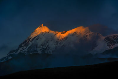 Scenic view of snowcapped mountains against sky during sunset