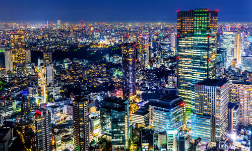 High angle view of illuminated city buildings at night